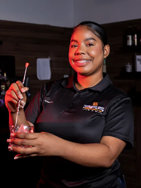 A bartender crafting a cocktail at 365 Sports Bar