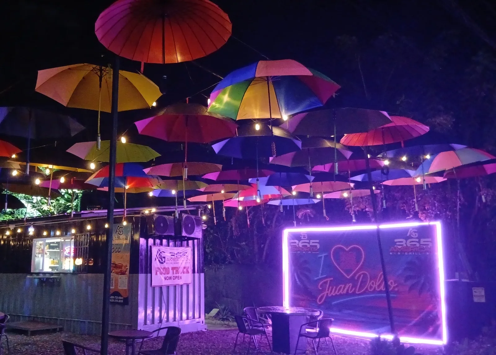 365 Beach Bar patio at night under colourful umbrellas